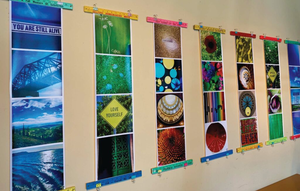 Sarah Johnson's photography exhibit, SOUL FUEL (about mindful seeking of what's good in the world), is displayed on a tan wall
